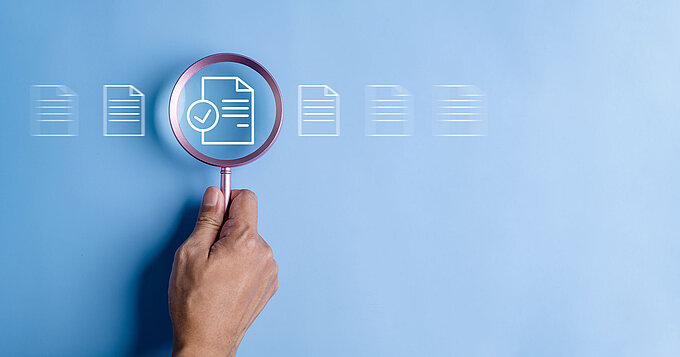 close up to hand, hold magnifier to search file to management. document is important too business.